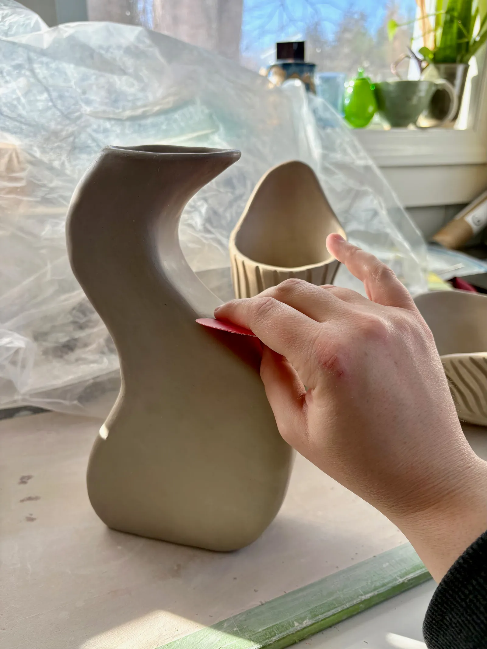 Smoothing a hand-built vase
