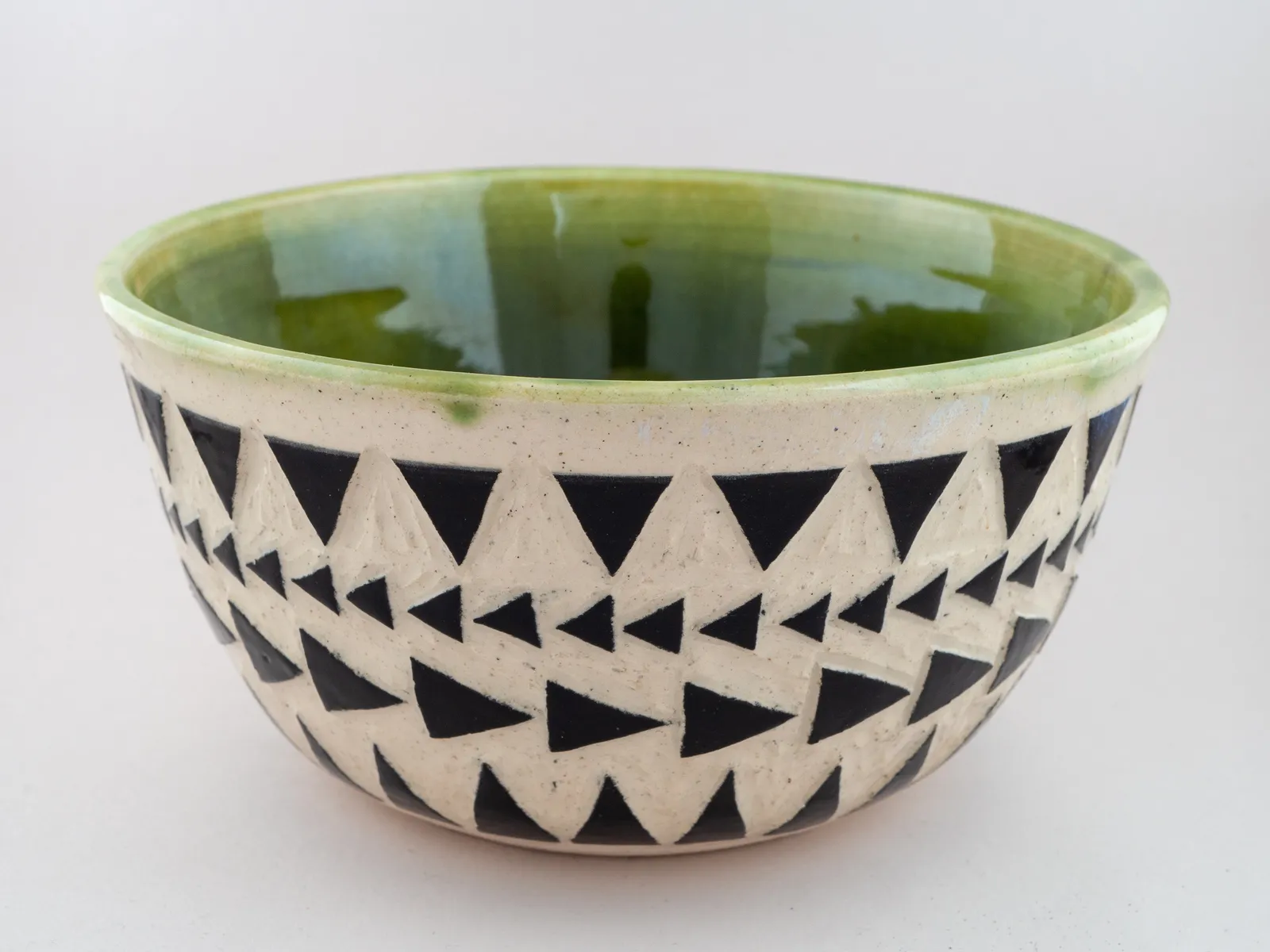 Sgraffito bowl, 2018, glazed stoneware fired to Cone 6 oxidation, 3 x 6 x 6 in. A black and white bowl carved in a geometric pattern.